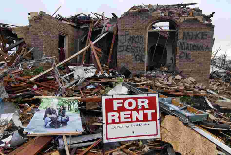 Graffiti informs rescuers that everyone is safe and accounted for at the site of a destroyed home on Monday in Joplin, Mo. 
