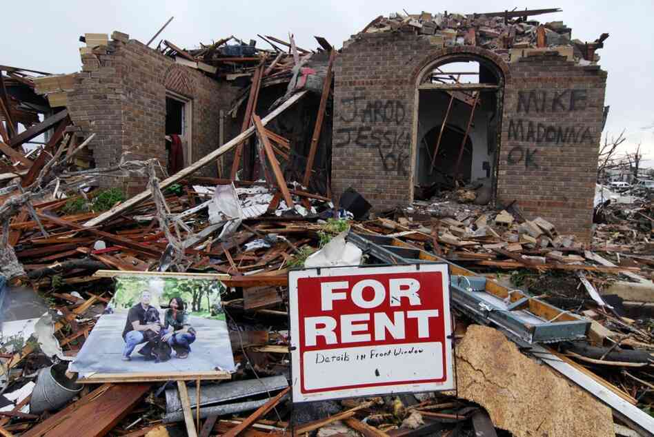 Graffiti informs rescuers that everyone is safe and accounted for at the site of a destroyed home on Monday in Joplin, Mo. 