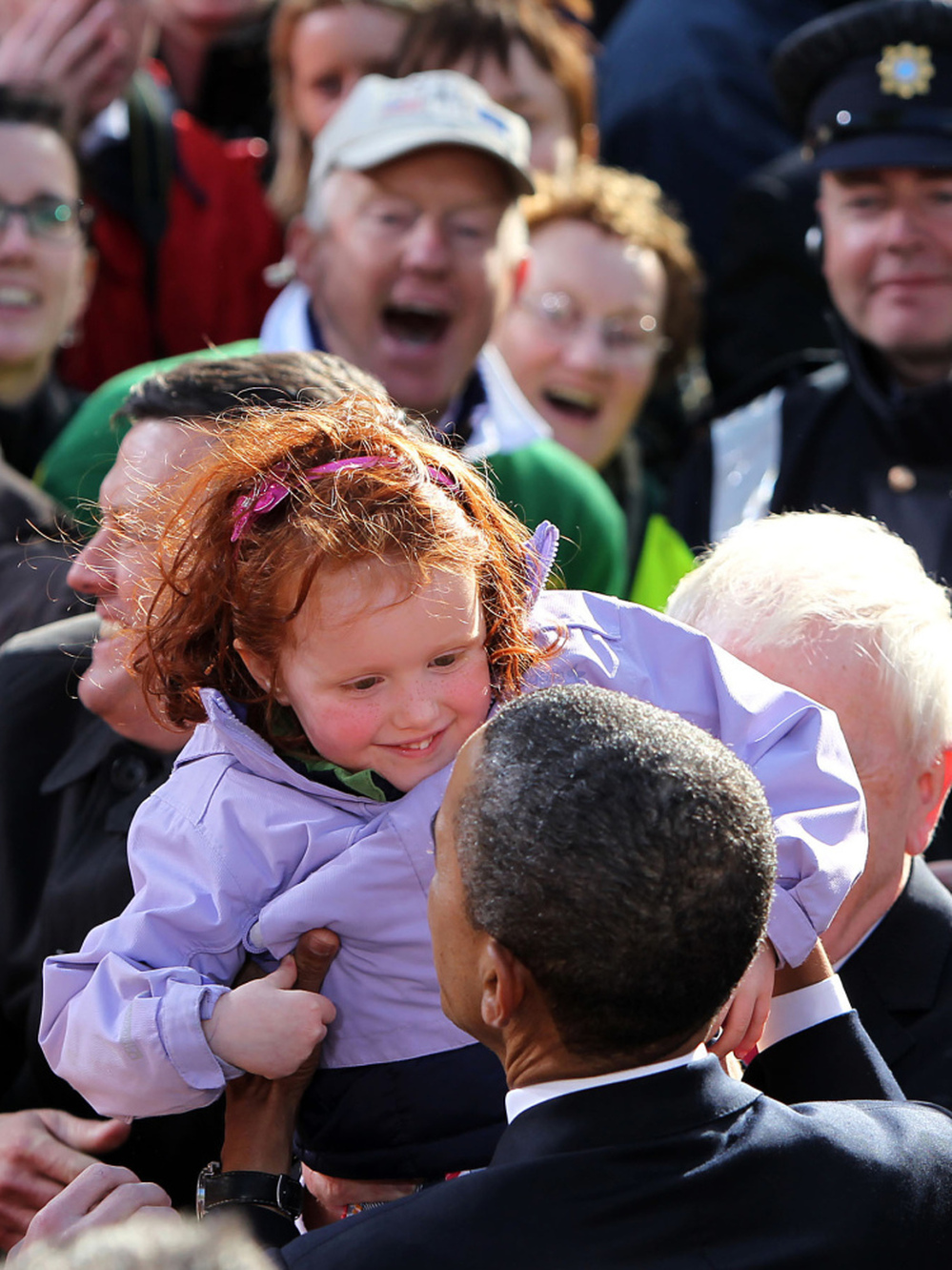 President Obama admires an Irish toddler to the delight of the crowd.