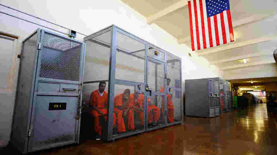 Inmates at California's Chino State Prison sit inside a metal cage in the hallway as they wait to be assigned permanent housing or for medical, mental health, counselor or other appointments.