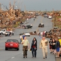 Residents of Joplin, Mo., walk west on 26th Street near Maiden Lane after a tornado hit the southwest Missouri city Sunday evening.
