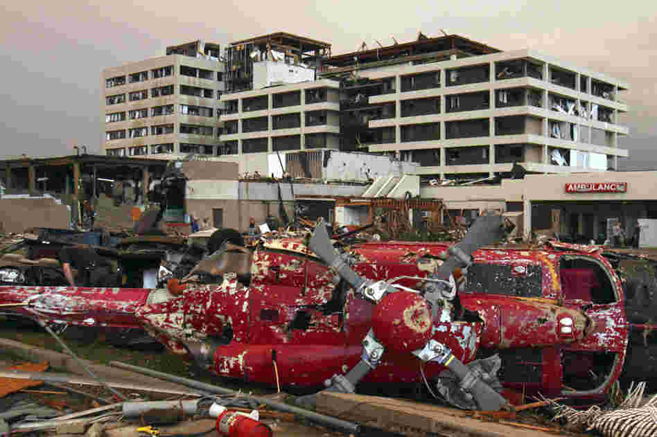 A destroyed helicopter lies on its side in the parking lot of the St. John's Regional Medical Center in Joplin. 