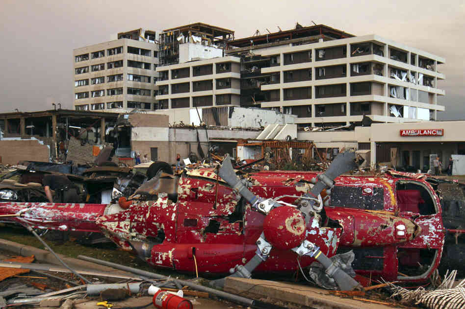 A destroyed helicopter lies on its side in the parking lot of the St. John's Regional Medical Center in Joplin. 