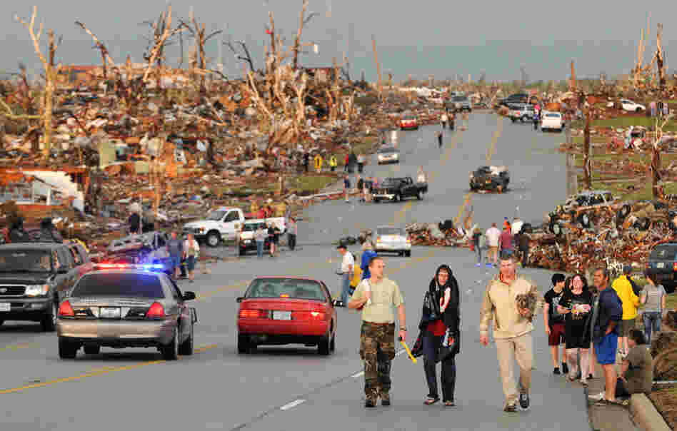 Residents of Joplin walk west on 26th Street near Maiden Lane. 