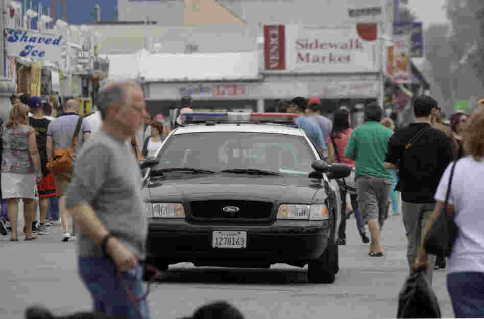 Los Angeles police patrol Ocean Front Walk in Venice Beach, a popular tourist destination, earlier this month. On April 16, a man was shot in an incident that police officials suspect was a flash mob organized on Twitter.