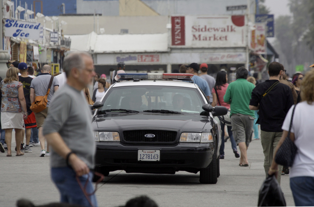 Los Angeles police patrol Ocean Front Walk in Venice Beach, a popular tourist destination, earlier this month. On April 16, a man was shot in an incident that police officials suspect was a flash mob organized on Twitter.