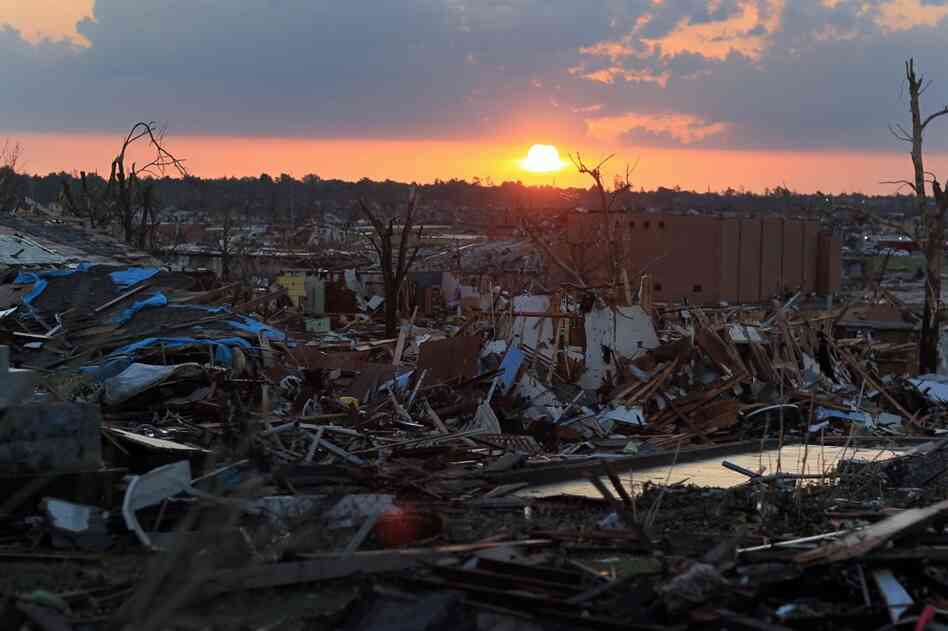 The sun rises over debris in Joplin, Mo. on Tuesday. 