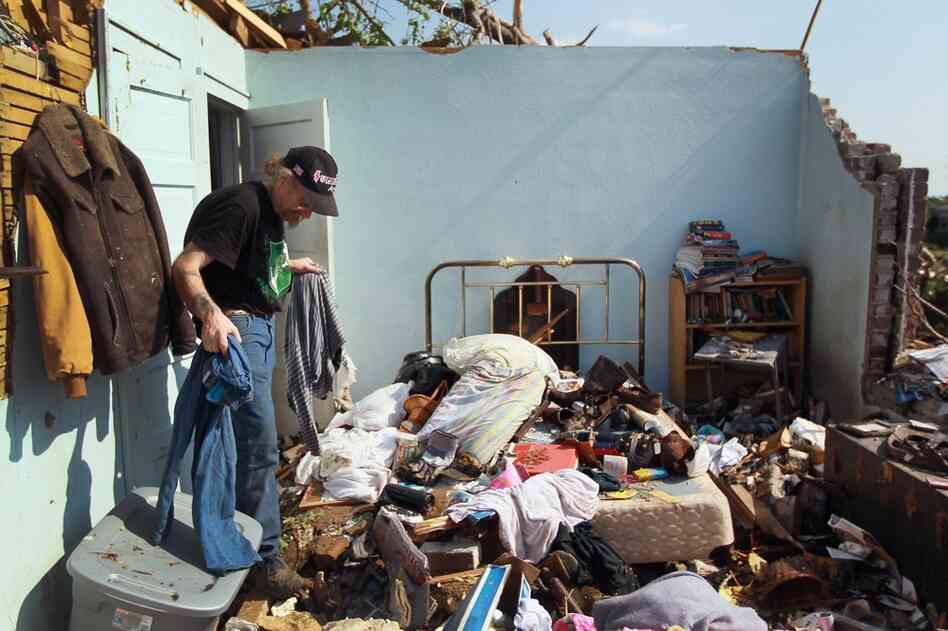 David Lane salvages what he can from his bedroom. 