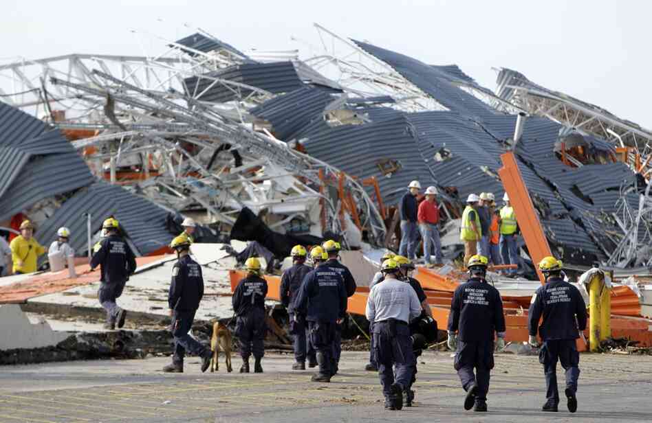Members of Missouri Task Force One search-and-rescue team work at a Home Depot that was hit by the tornado. 