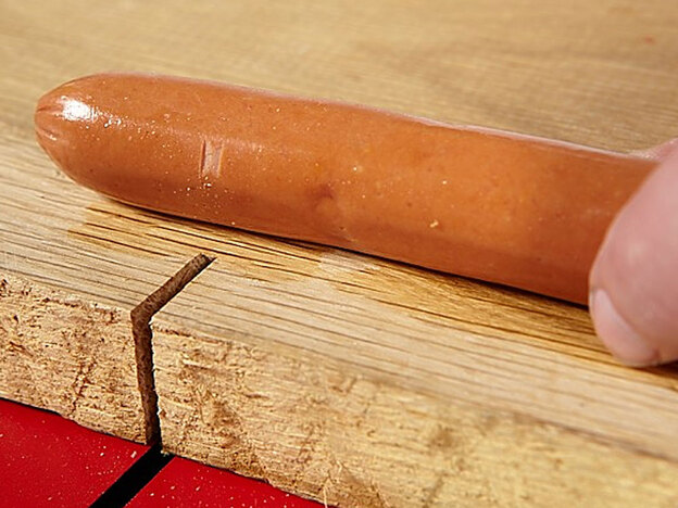 A hot dog with a slight nick
