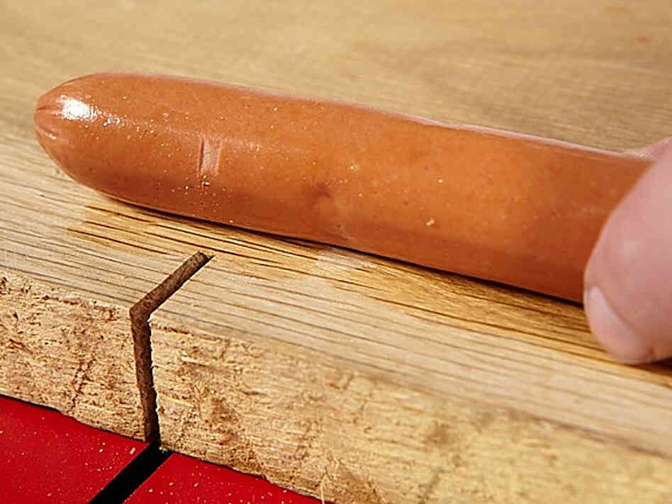 A hot dog with a slight nick