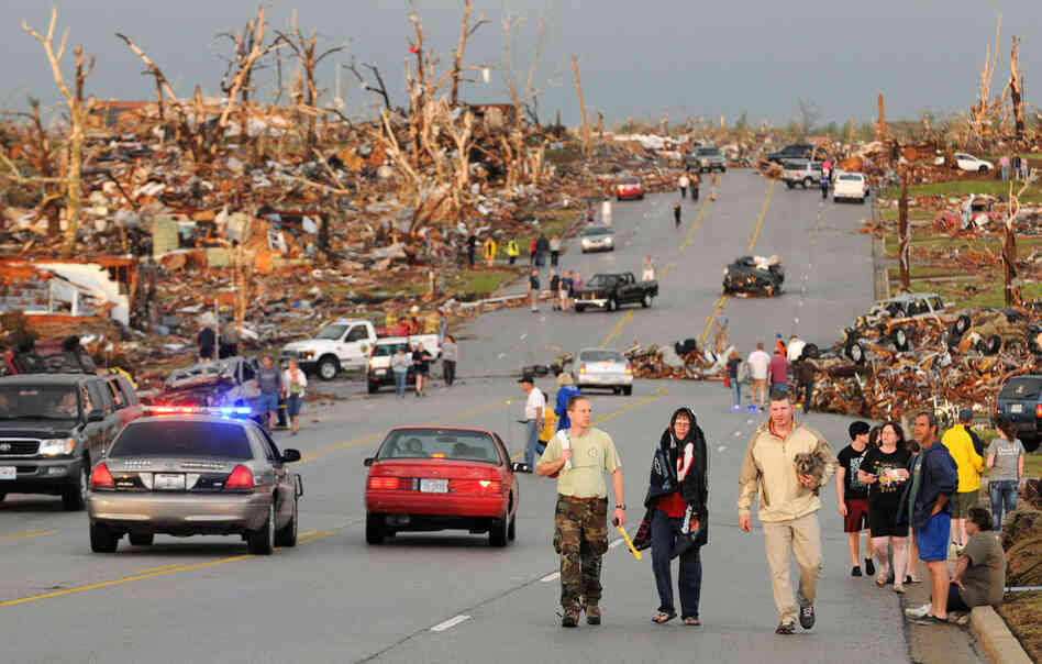 Residents of Joplin walk west on 26th Street near Maiden Lane. 