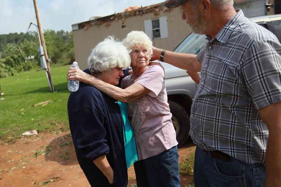 Kathy McCormick (left), Alice Vandenberg and William Schaffer console each other as they deal with the loss of their families homes Denning, Ark. 