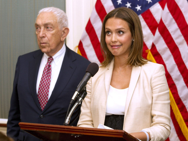 Actor Jessica Alba, accompanied by Sen. Frank Lautenberg (D-NJ), reacts when a buzzer calling for a vote goes off during a news conference on Capitol Hill Tuesday about chemical regulation.