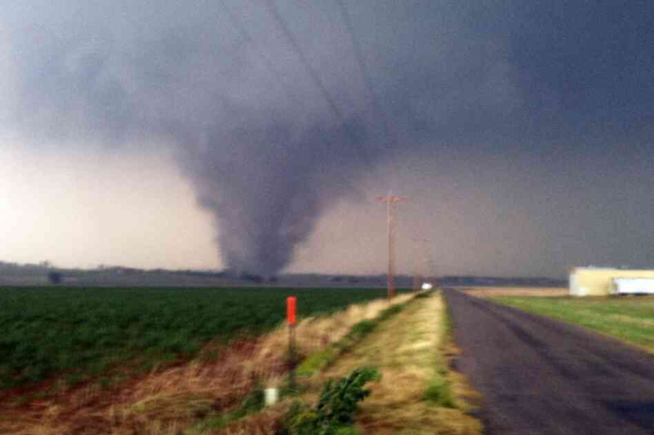 A tornado touches down near Chickasha, Okla., on Tuesday. A line of violent thunderstorms roared across middle America on Tuesday, killing several people. 