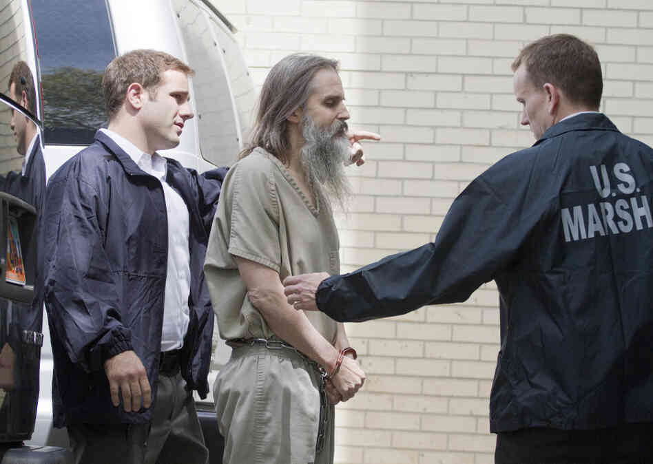 Brian David Mitchell is escorted into the Frank E. Moss Federal Courthouse in Salt Lake City.