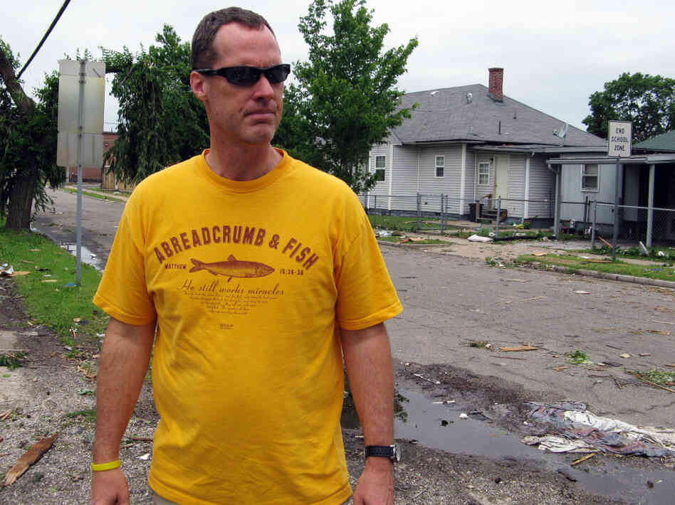 Thomas Herrod inspects roof damage in Joplin.