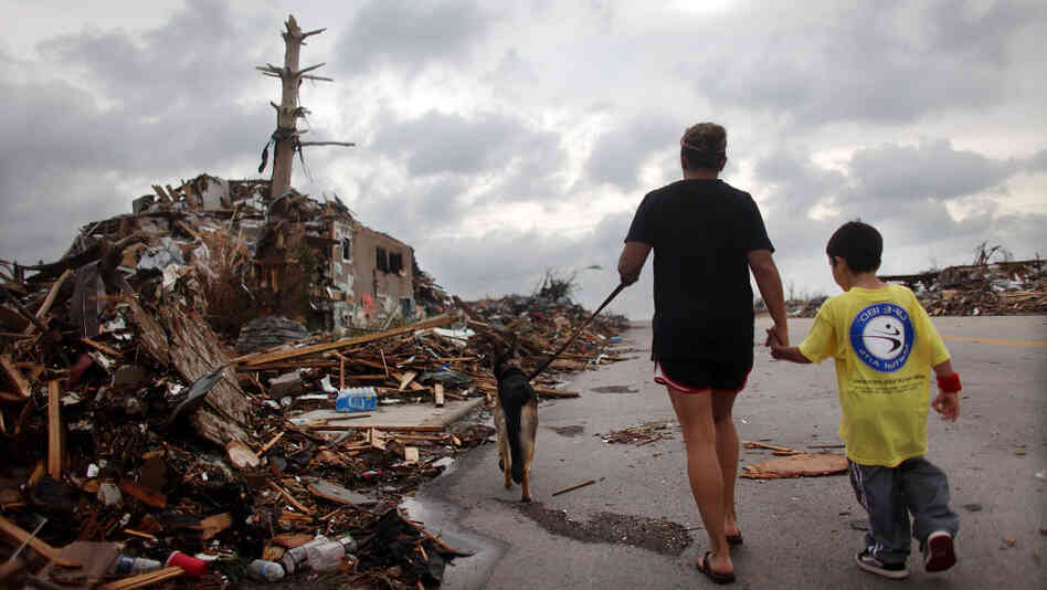 Kimmy Lankford and her 5-year-old son, Jack, walk through their neighborhood Wednesday after a massive tornado passed through the town. The Lankfords continue to live in their home a few blocks away, which was damaged but remains habitable. Kimmy Lankford and her 5-year-old son, Jack, walk through their neighborhood Wednesday after a massive tornado passed through the town. The Lankfords continue to live in their home a few blocks away, which was damaged but remains habitable.