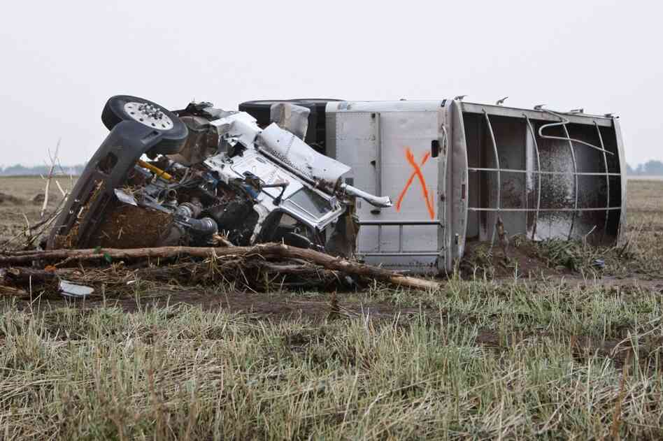A truck lies in a field following a tornado in Piedmont. The "X" is usually an indication that a vehicle has been checked for survivors. 