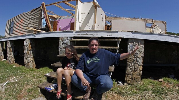 Amy Womack and her daughter, Alexis Nelson, sit on the front steps of her parents' house in Cleveland, Tenn., in late April. Womack says her father urged her and 13 relatives and friends into the basement before a tornado hit; she credits him with saving their lives. Amy Womack and her daughter, Alexis Nelson, sit on the front steps of her parents' house in Cleveland, Tenn., in late April. Womack says her father urged her and 13 relatives and friends into the basement before a tornado hit; she credits him with saving their lives.
