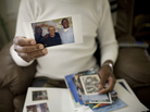 Robert Dixon Sr. holds a photograph of his son, Robert Dixon Jr. (far right), his son's mentor Bob Stuart, and himself (far left). Robert Dixon Sr. holds a photograph of his son, Robert Dixon Jr. (far right), his son's mentor Bob Stuart, and himself (far left).