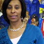 Janice Richardson, principal of Carstens Elementary School, stands in front of a  mural in the school's entryway. The Detroit Public School system is losing thousands of students, and Carstens  may have to close or become a charter.