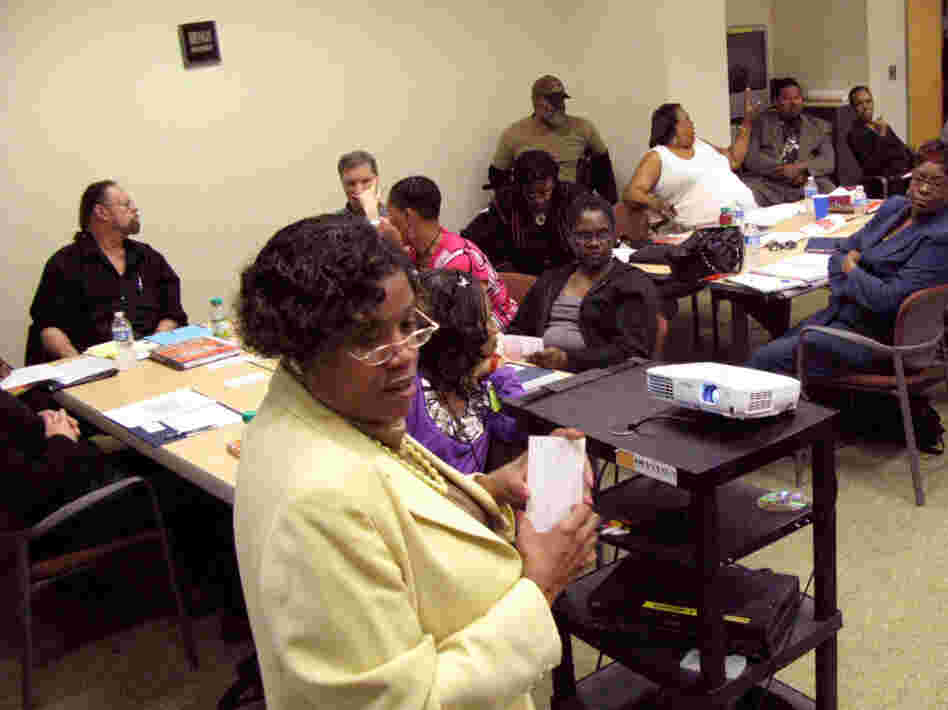 Angie Melhado, a charter school consultant, talks to parents and community members who are considering serving on charter school boards. Detroit wants to convert dozens of traditional schools to charters, but many in the city remain skeptical about the plan. Angie Melhado, a charter school consultant, talks to parents and community members who are considering serving on charter school boards. Detroit wants to convert dozens of traditional schools to charters, but many in the city remain skeptical about the plan.