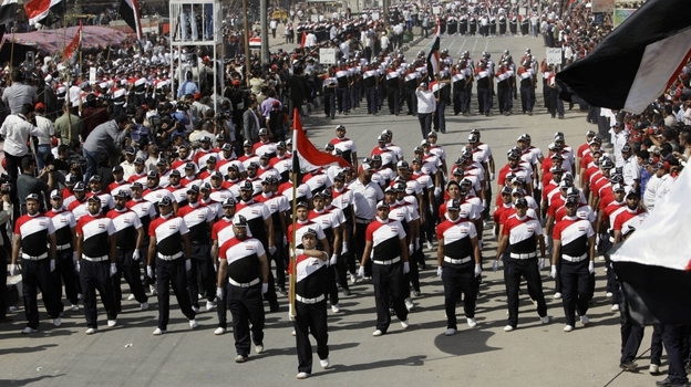 Militiamen loyal to cleric Muqtada al-Sadr march in the Sadr City district of Baghdad Thursday. Tens of thousands of followers of the Shiite anti-American cleric are rallying in Baghdad, demanding the U.S. military leave Iraq at the end of the year. Militiamen loyal to cleric Muqtada al-Sadr march in the Sadr City district of Baghdad Thursday. Tens of thousands of followers of the Shiite anti-American cleric are rallying in Baghdad, demanding the U.S. military leave Iraq at the end of the year.