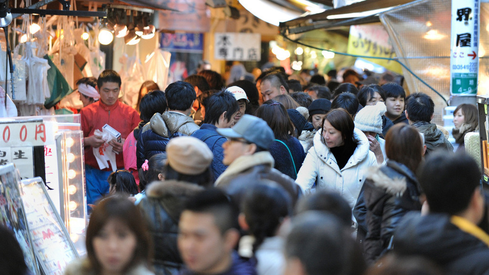 Shoppers crowd a narrow street outside Tsukiji market in Tokyo on Dec. 31, 2010. Japan has relatively tight social rules. And that makes sense, according to researchers. When people are squeezed together, they have an incentive to cooperate.