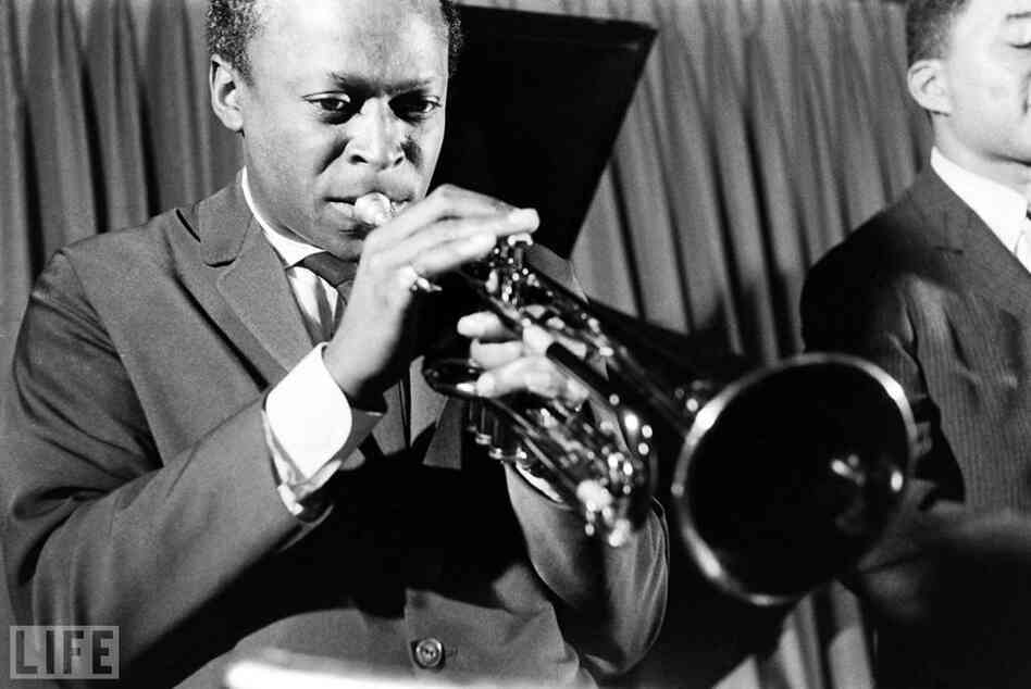 Miles Davis. Bassist Paul Chambers is to his left.