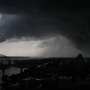 A line of severe storms crosses the Mississippi River in Memphis, Tenn., passing by the Memphis Pyramid on Wednesday. The dark formation was reported a few minutes earlier as a tornado in West Memphis, Ark.