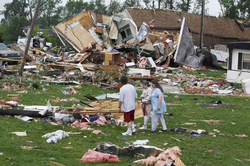 Residents examine the damage from a severe storm that hit a trailer park in Bloomington, Ind., on Thursday. 