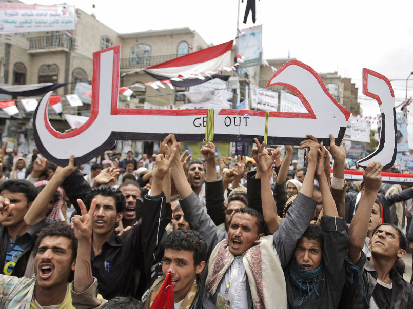 Anti-government protesters hold up a placard that reads "Leave" in Arabic during a demonstration demanding the resignation of President Ali Abdullah Saleh in Sanaa, Yemen, on Thursday.