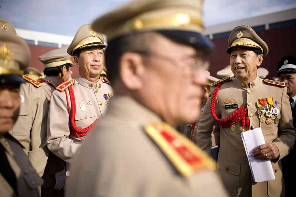 Col. Wangyee Vang (right) president of the Lao Veterans of America Institute, reunites with other veterans at the funeral procession for Gen. Vang Pao.