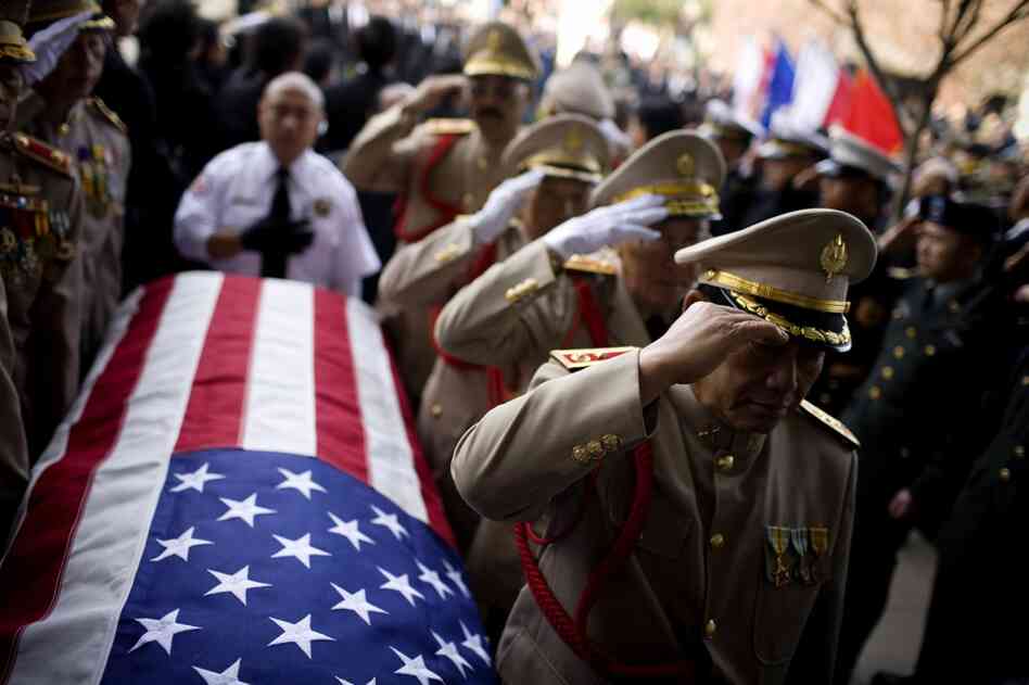 Military officials salute the casket of Gen. Vang Pao during his funeral procession in Fresno, Calif., on Feb. 4. In the 1970s, Vang led Hmong guerrillas in a CIA-backed battle against communist forces in Laos and helped tens of thousands of Hmong immigrants resettle in American cities.