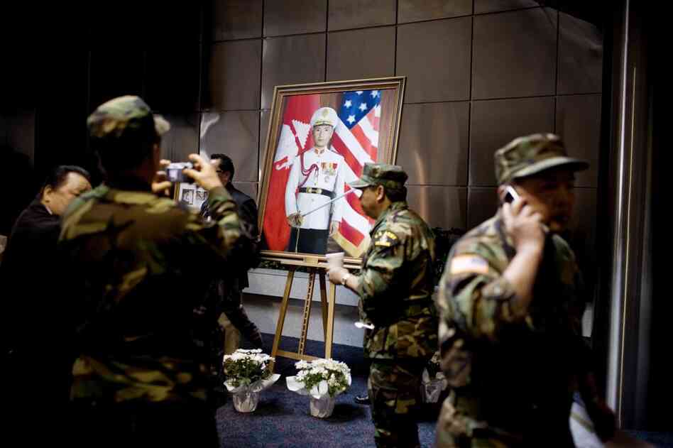 Former U.S. soldiers surround a portrait of Gen. Vang Pao.  They were among the thousands attending the general's funeral.