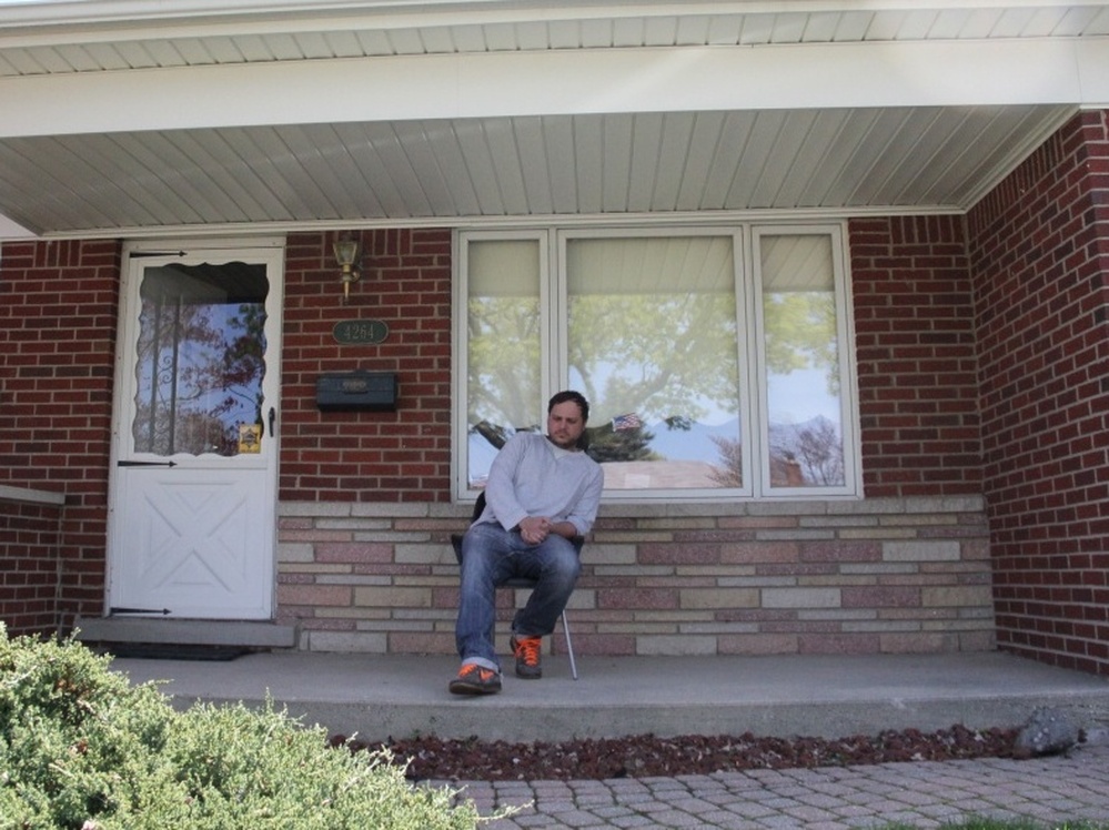 Brian Gillespie in front of his home.
