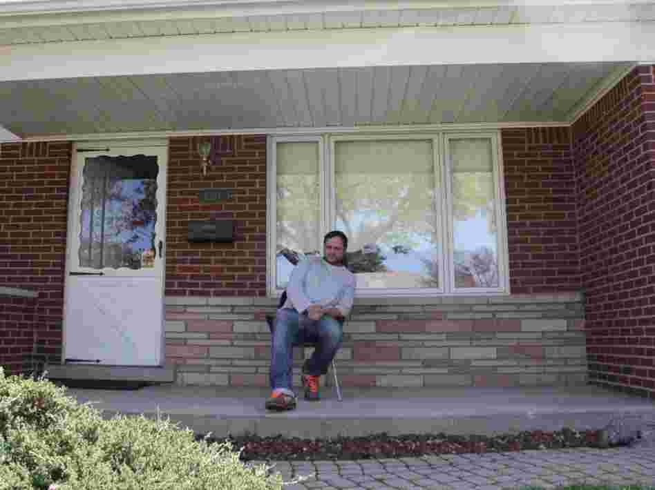 Brian Gillespie in front of his home.