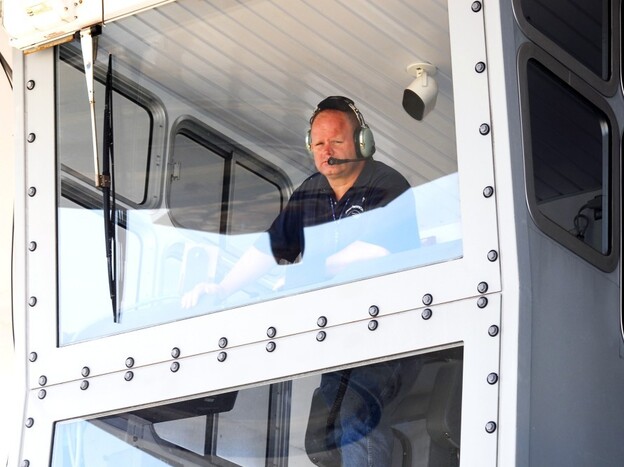 Bill Couch looks down from the cab of the crawler.  Couch is one of only six people certified to drive the enormous machine.