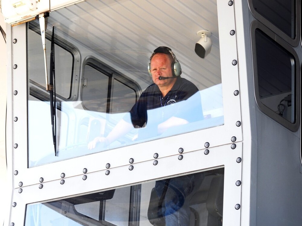 Bill Couch looks down from the cab of the crawler.  Couch is one of only six people certified to drive the enormous machine.
