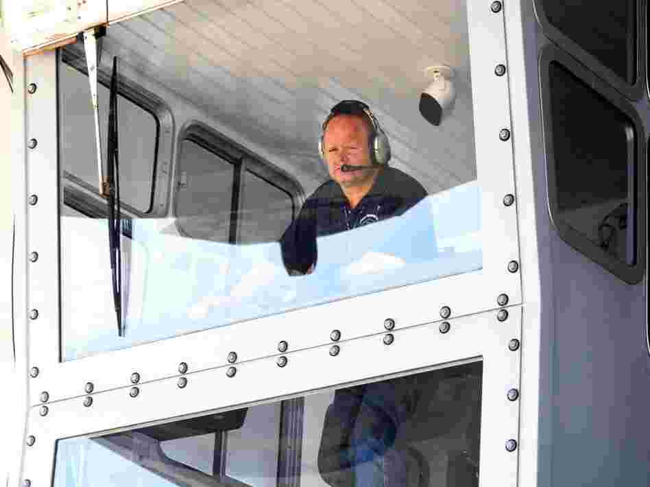 Bill Couch looks down from the cab of the crawler.  Couch is one of only six people certified to drive the enormous machine.