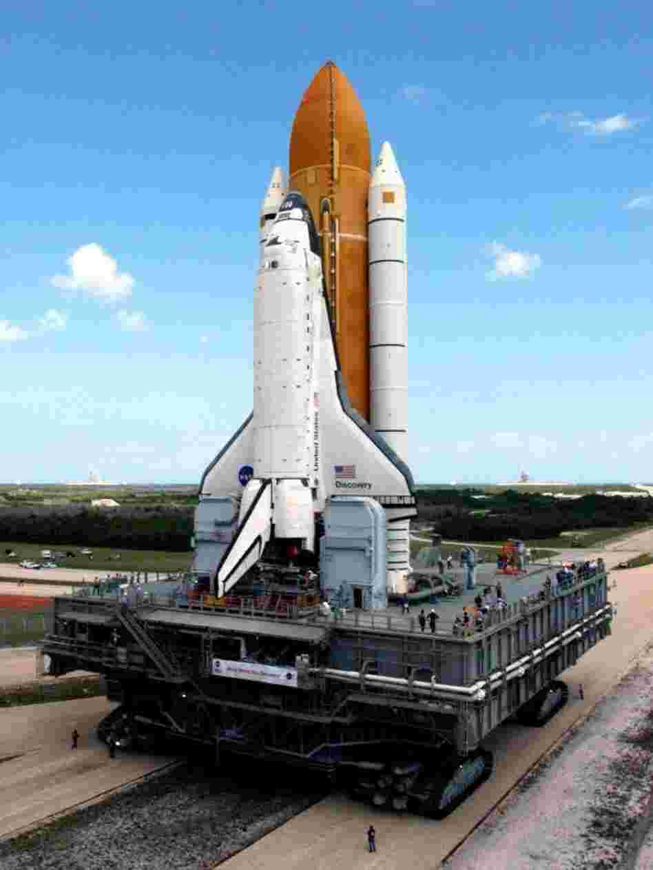 The crawler inches toward Launch Pad 39B at the Kennedy Space Center in 2005, traveling 1 mph and burning a gallon of gas every 32 feet. In 2005, its precious cargo was space shuttle Discovery; for its last trip at the end of May, the crawler will transport space shuttle Atlantis to its final launch.