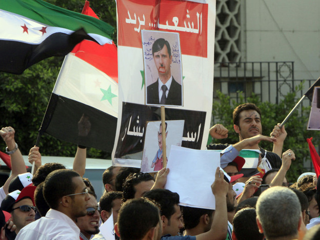 Protesters demand that Syrian President Bashar al-Assad step down, in front of Arab League headquarters in Cairo.