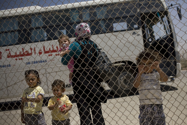 A Palestinian family waits to cross from the Gaza Strip into Egypt through the Rafah border crossing on Saturday.