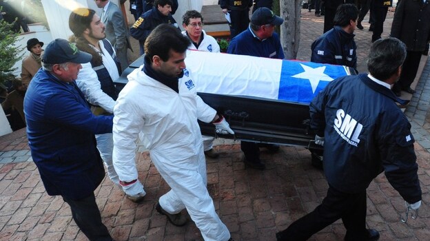 Forensic personnel transport the coffin with the remains of former Chilean President Salvador Allende at the General Cemetery in Santiago on May 23.