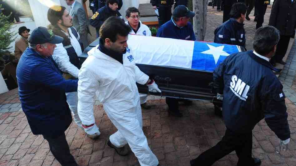 Forensic personnel transport the coffin with the remains of former Chilean President Salvador Allende at the General Cemetery in Santiago on May 23.