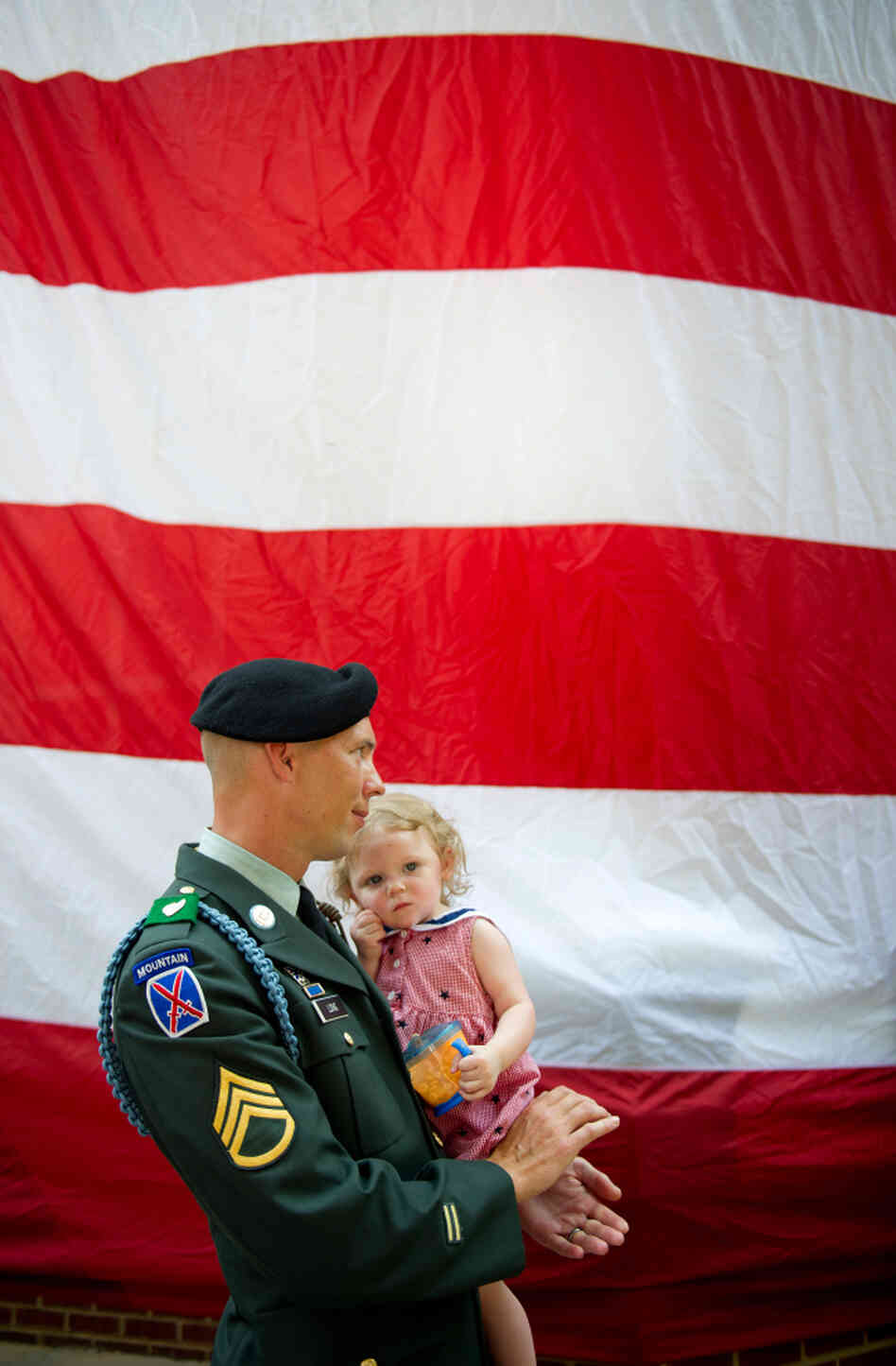 Jacob Long of the Georgia Army National Guard holds his 14-month-old daughter, Charlotte, during a Memorial Day ceremony in Roswell, Ga., on Monday. Jacob Long of the Georgia Army National Guard holds his 14-month-old daughter, Charlotte, during a Memorial Day ceremony in Roswell, Ga., on Monday.
