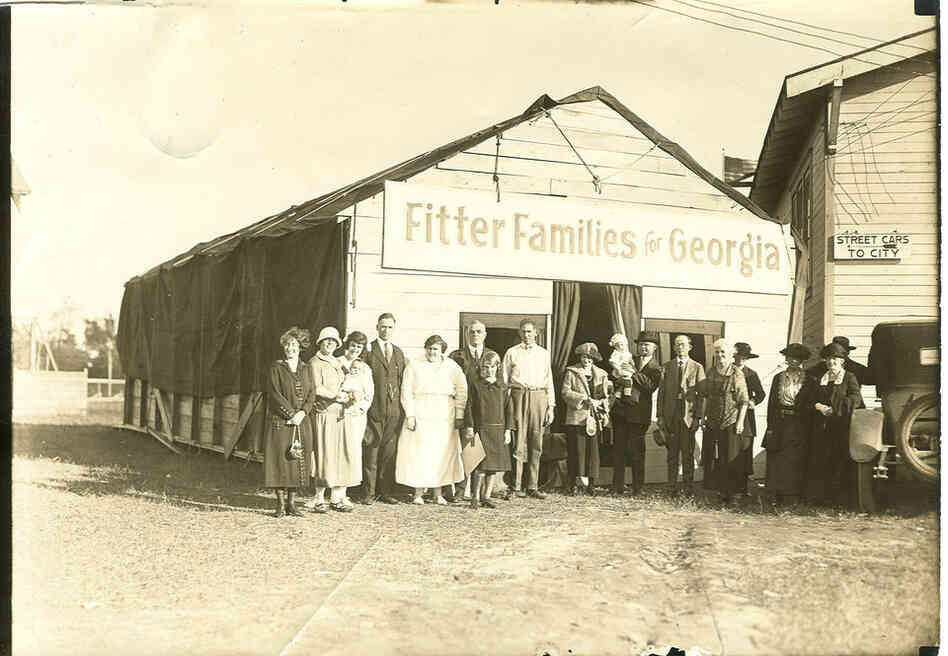 People pose outside the "Fitter Families" headquarters at the Georgia State Fair in Savannah, 1924.