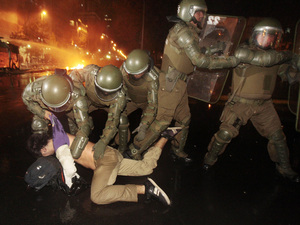 Police officers detain a demonstrator during clashes after a protest in front of La Moneda government palace in Santiago, Chile, May 20. The protest was against a $7 billion project by the multinational consortium HidroAysen to dam two of the world's wildest rivers in Patagonia for electricity. Police officers detain a demonstrator during clashes after a protest in front of La Moneda government palace in Santiago, Chile, May 20. The protest was against a $7 billion project by the multinational consortium HidroAysen to dam two of the world's wildest rivers in Patagonia for electricity.