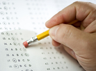 Man erases answer to a test question. Man erases answer to a test question.